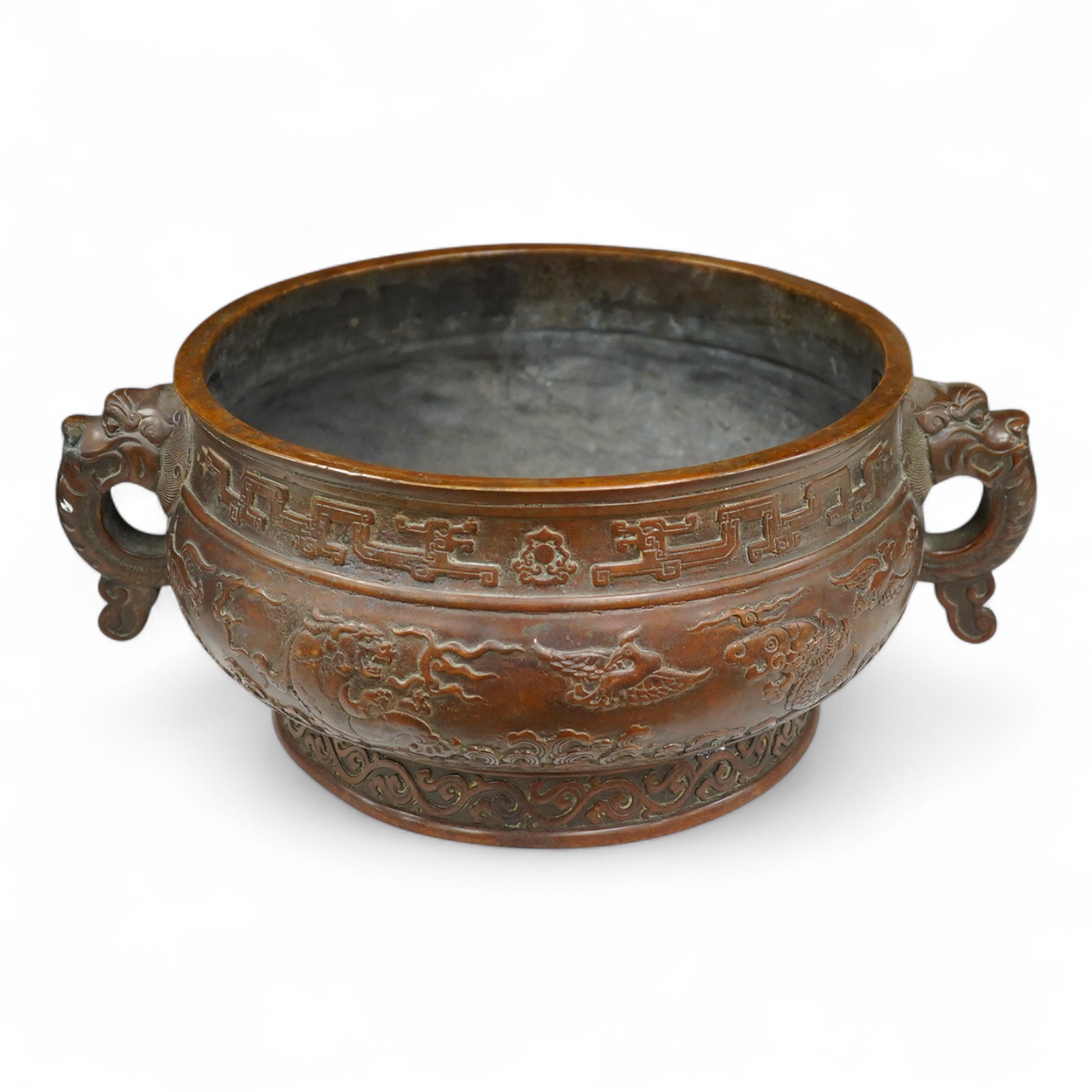 A large Chinese archaistic bronze censer, decorated in relief, with twin handles, 38cm in diameter